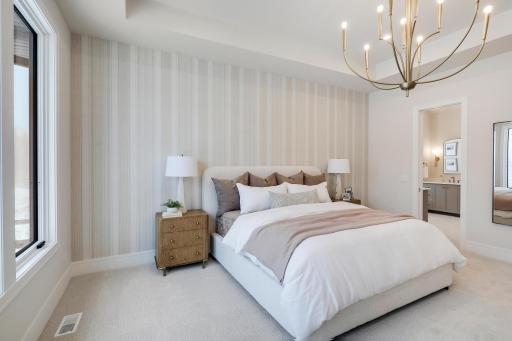 Pretty wallpaper and light fixtures create a warm ambiance