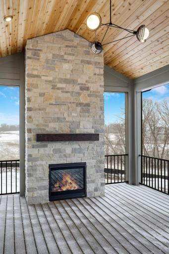 Stone fireplace. Porch leads to open deck and back yard