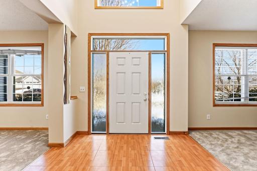 Spacious inviting foyer with new Provia door with privacy glass, and light enhancing sidelights and transom