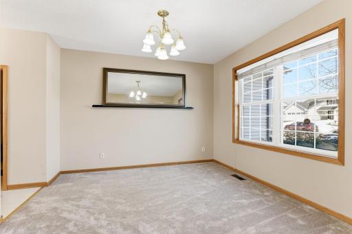 Formal dining room with light enhancing window