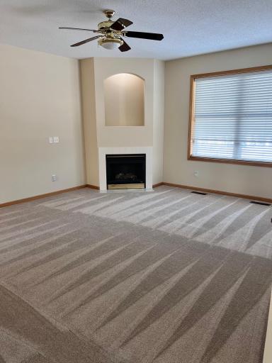 A spacious living room with a gas-burning fireplace sets the tone for comfort and understated luxury.