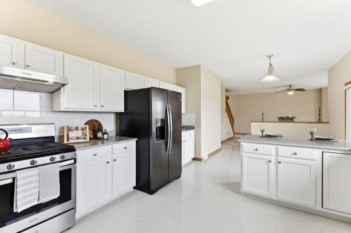 Spacious kitchen with newer black stainless steel appliances and updated newly painted kitchen cabinets