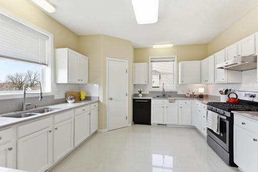 Freshly painted kitchen cabinets; large walk-in pantry with dual sinks and ample solid surface countertops with loads of storage! Kitchen window with beautiful golf course views above sink.