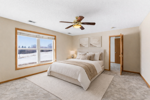 Lower level bedroom #6 with walk-in closet and large window with beautiful views. Virtually staged.