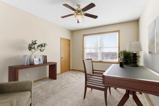 Main level bedroom with spacious walk-in closet; 6 of the 7 bedrooms have large walk-in closets! Virtually staged as an office.