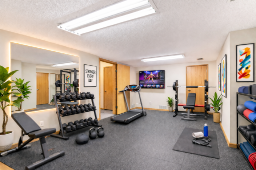 The large storage room virtually staged as a modern home gym with motivational vibes...