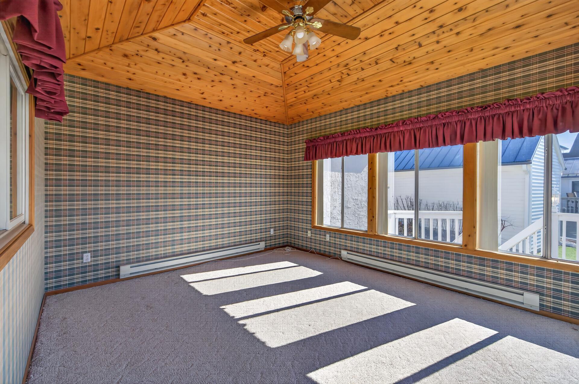 3 season porch with baseboard heat and ceiling fan