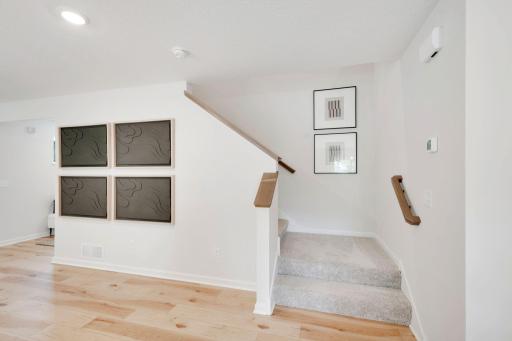 Staircase leading to your upper level with 4 of the 5 bedrooms, two baths, laundry and huge loft!