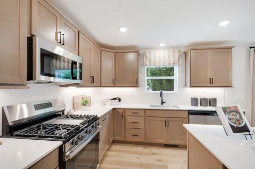 Silestone quartz countertops in the kitchen are non-porous, bacteria resistant and low maintenance, with no sealing required! Sink overlooks your backyard.