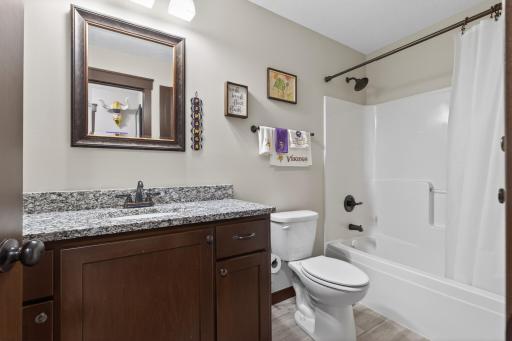 Lower level full hall tile bath with granite counter top