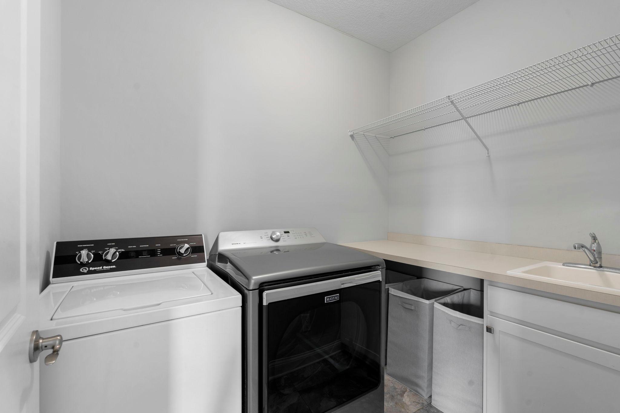 Upper level laundry. Laundry sink, extra space for hampers, hanging and storage!