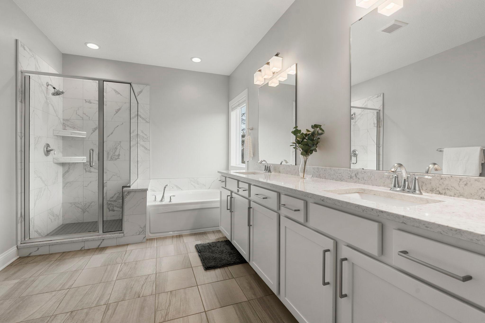 The primary bath boasts double sink vanity, separate shower, tub...