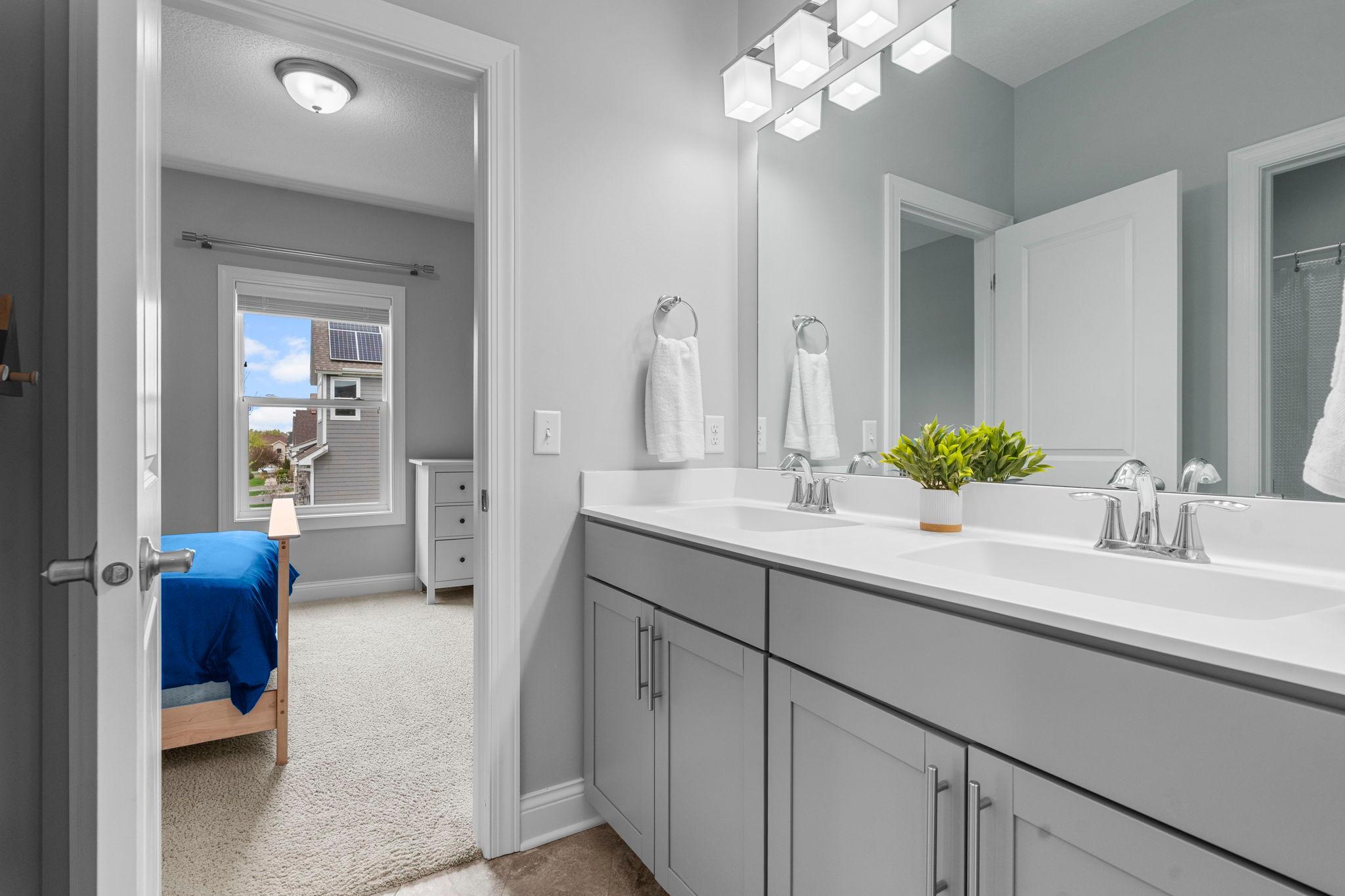 Jack and Jill bathroom between bedrooms 3 & 4. Double sink vanity.