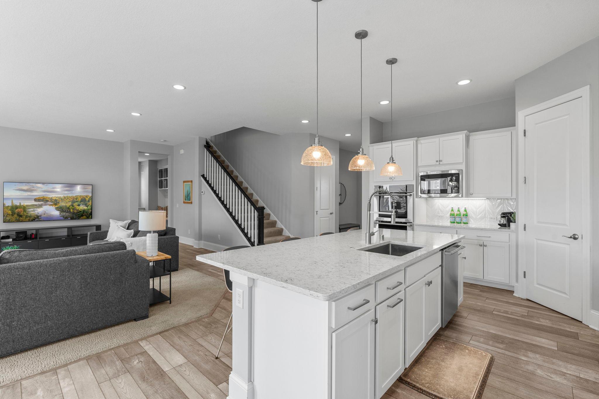 double ovens, gas cooktop, french door refrigerator, and a pretty and powerful hood fan.
