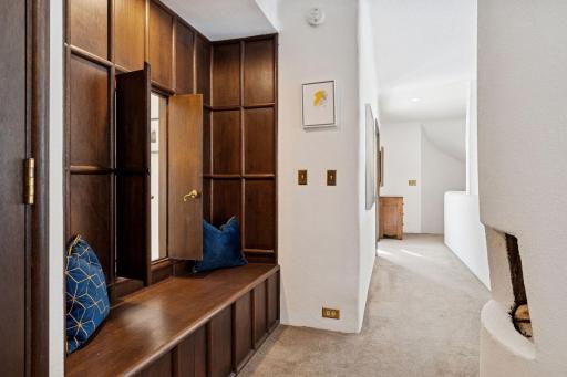 Cozy bench gives a great view of the second level fireplace from the primary bathtub.