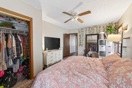 Main floor bedroom complete with overhead fan/lighting and dual closets.