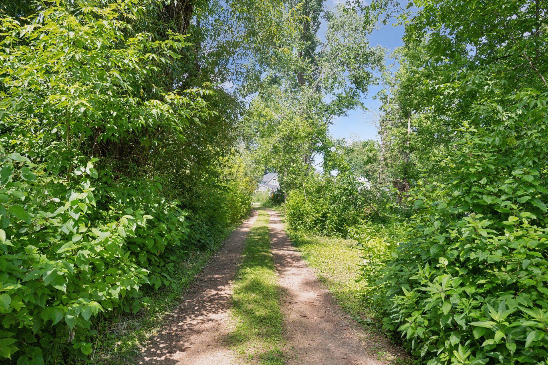 Tucked away at the end of a long, driveway, the home offers a secluded, “up north” feel—yet you're just minutes from downtown, shopping, parks, and trails.