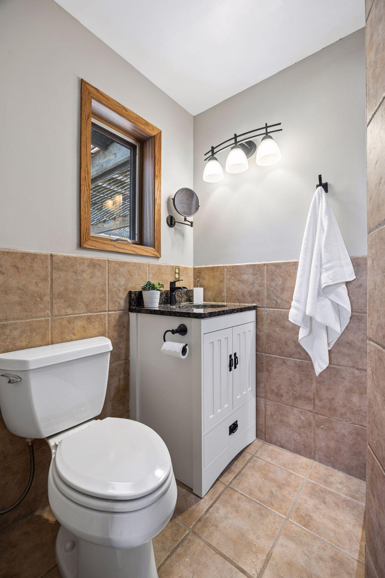Primary bath features beautiful tile flooring and shower surround.