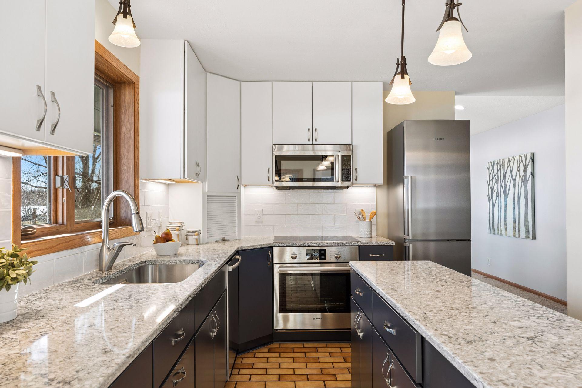 Timeless kitchen with white upper cabinets and navy lower cabinets.