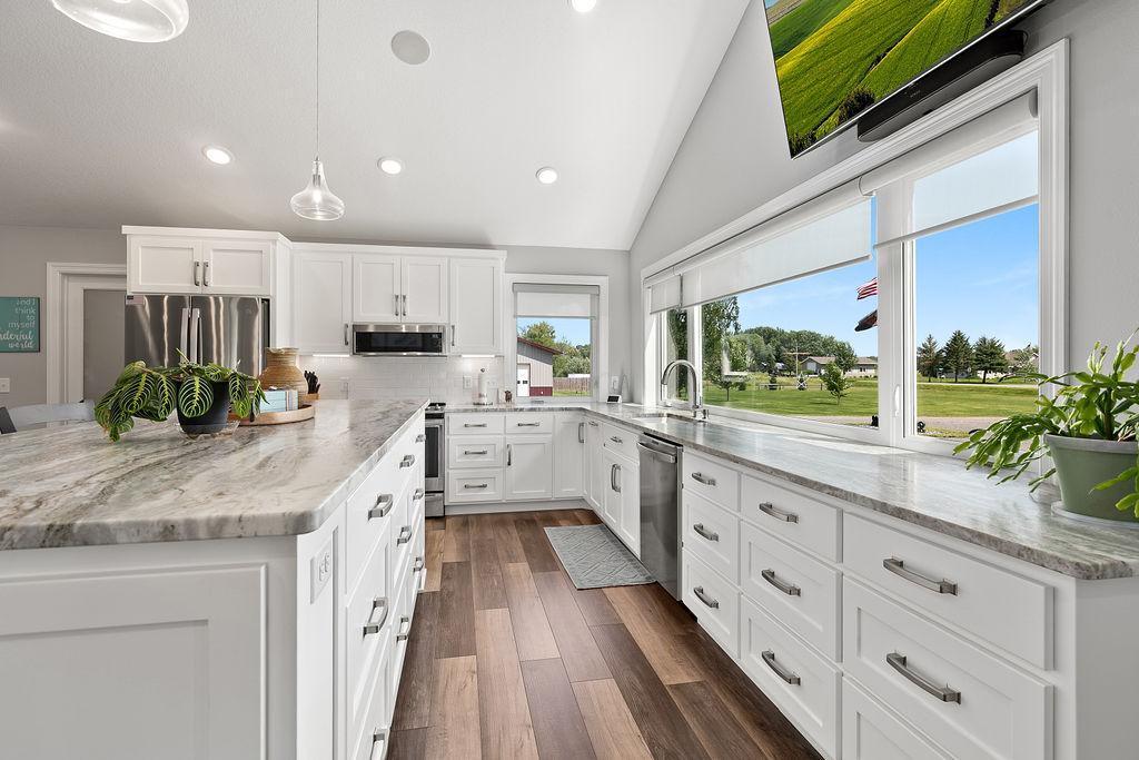 Granite counter tops, Big window over sink looking out at the driveway