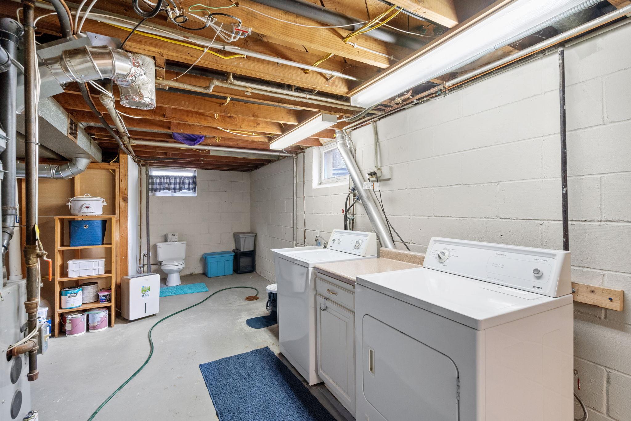 Spacious and clean utility room with even more storage.