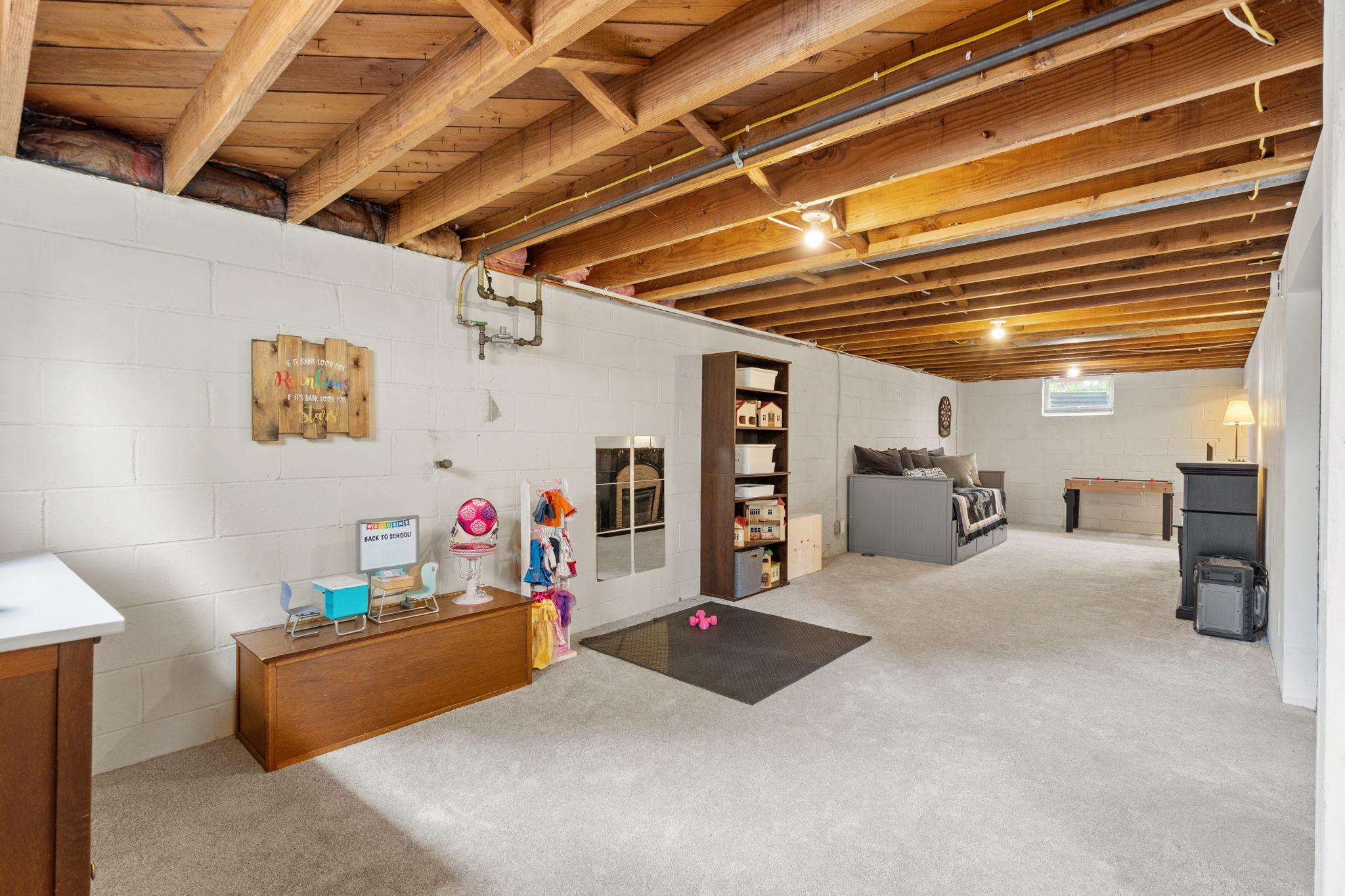 Lower level flex space is carpeted and partially drywalled.