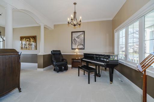 Two flex spaces with subtle room delineation lie off the entry and feature crown molding, neutral paint colors and new lighting. The half walls and columns are not structural and can be removed if desired.