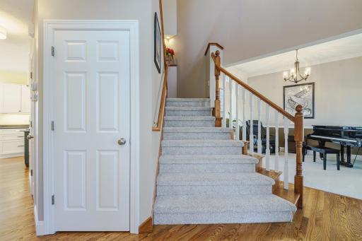 The angled staircase frames the foyer, which is flanked by the office and the music (living) room.