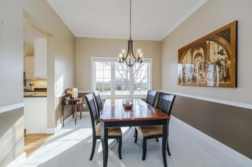 The dining room also has crown molding and new lighting. This space connects to the kitchen and overlooks the park.