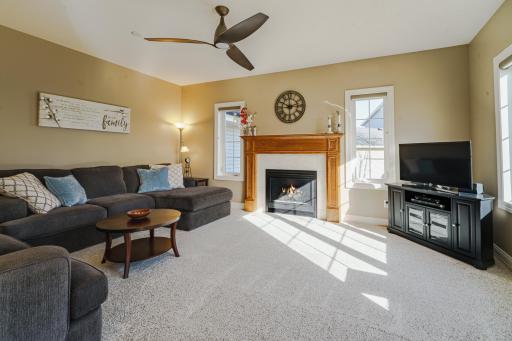 The family room features windows on two sides, a ceiling fan, and a gas fireplace. This comfortable space is both open yet private, and takes in park views.