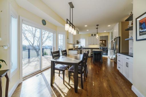 The 22x12 deck right off the kitchen offers endless entertaining and relaxation opportunities. The kitchen is is light and bright, with classic white cabinetry with updated hardware and vibrant lighting.
