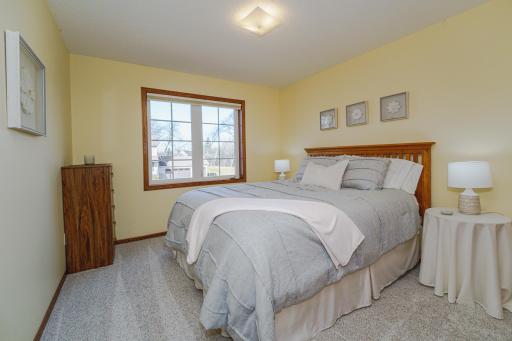 This is one of four upper level bedrooms. This room has a soothing color palette and overlooks the front of the home.