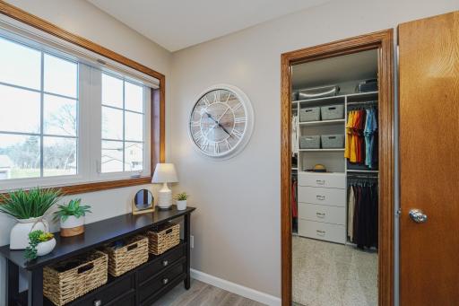 The walk-in closet is connected to the bath and has custom organizers from Closet Factory. The original doors to the commode and the walk-in closet are available and will stay with the home.