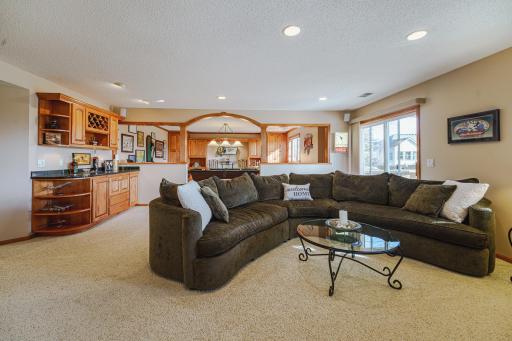The layout of this space is so comfortable, and it feels like an extension of the upper level with the windows and light. The half wall is non-load-bearing and removable if desired.
