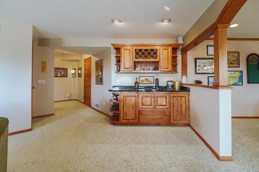 A serving bar with granite countertops has a microwave in the lower level cabinet. Water access, should any be desired in the future, can be plumbed in via the utility room.