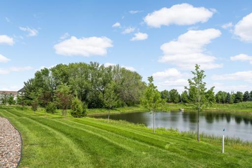 A beautiful pond setting provides a peaceful backdrop and extra privacy behind the home.