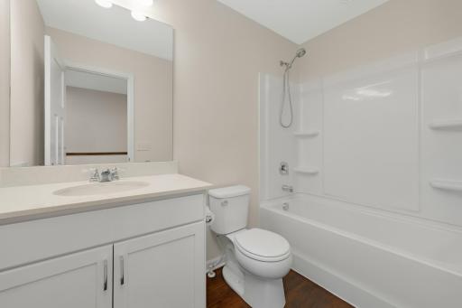 Full upper-level bath with quartz vanity, and tub/shower surround.