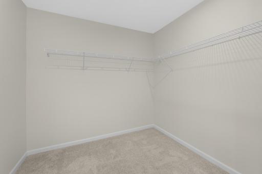 Large walk-in closet offers plenty of room for clothing, shoes, and seasonal storage.