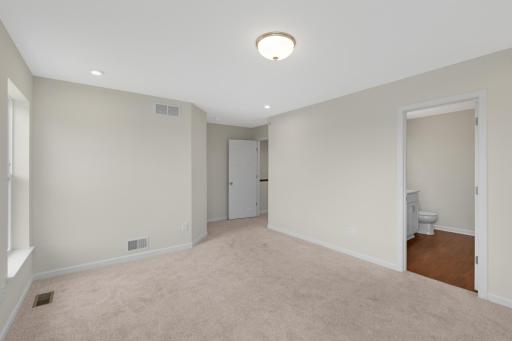Another view of the Owner's Suite showcasing its generous size and flexible furniture layout options.