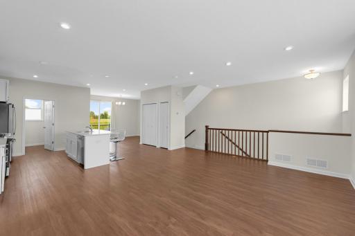Recessed lighting and durable LVP flooring extend throughout the main living area.