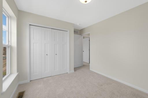 Secondary bedroom includes a double-door closet and neutral finishes ready for your personal touch.