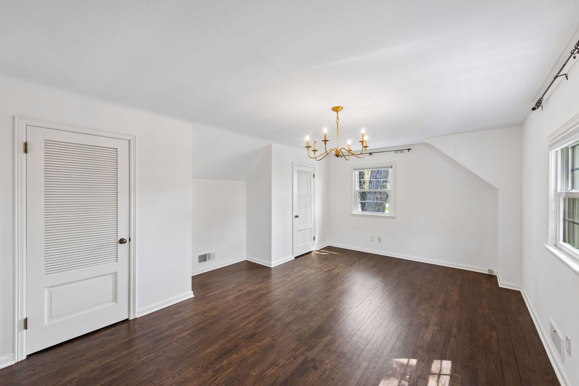 Spacious upper-level bedroom with hardwood floors