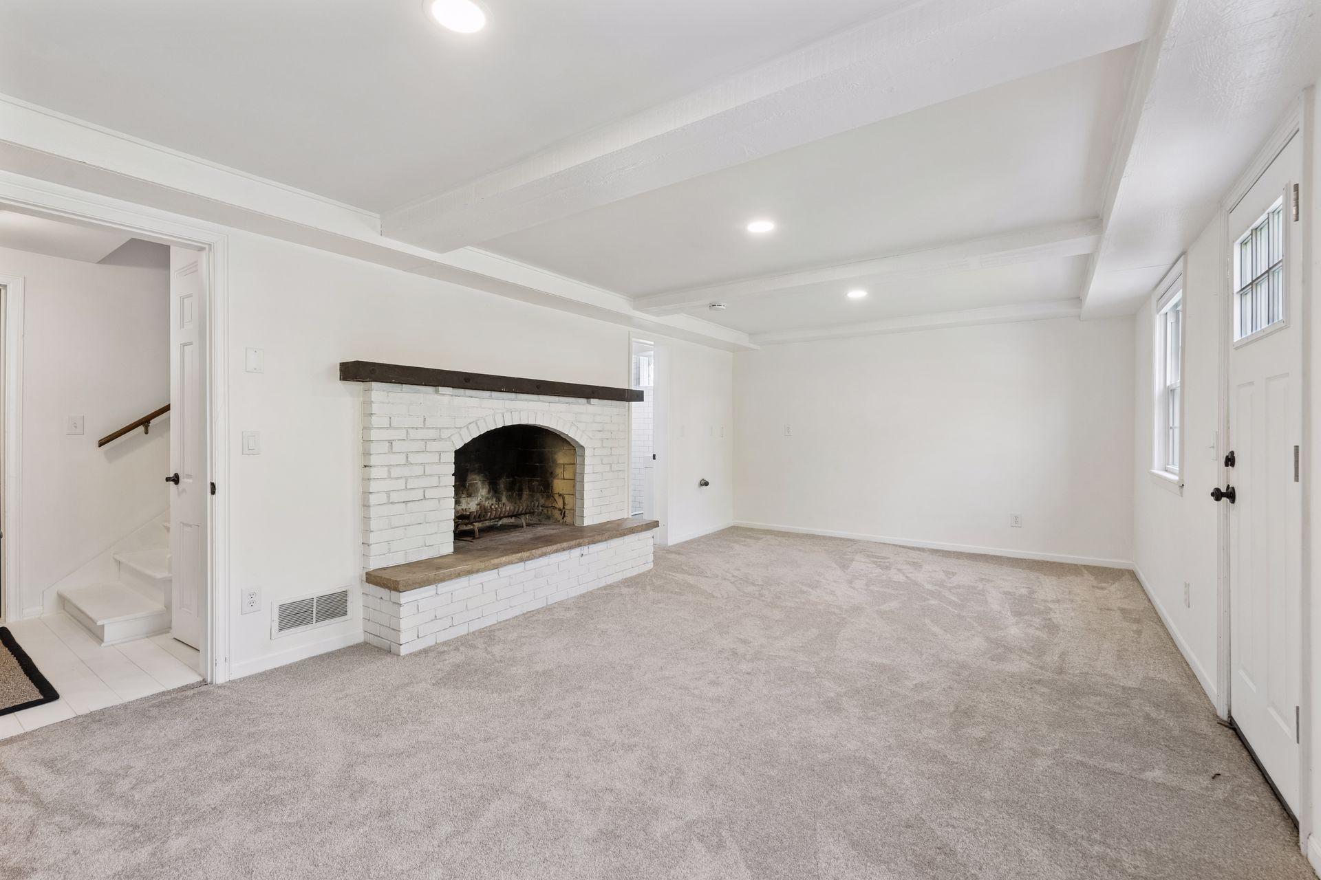 Cozy lower-level family room with wood-burning fireplace