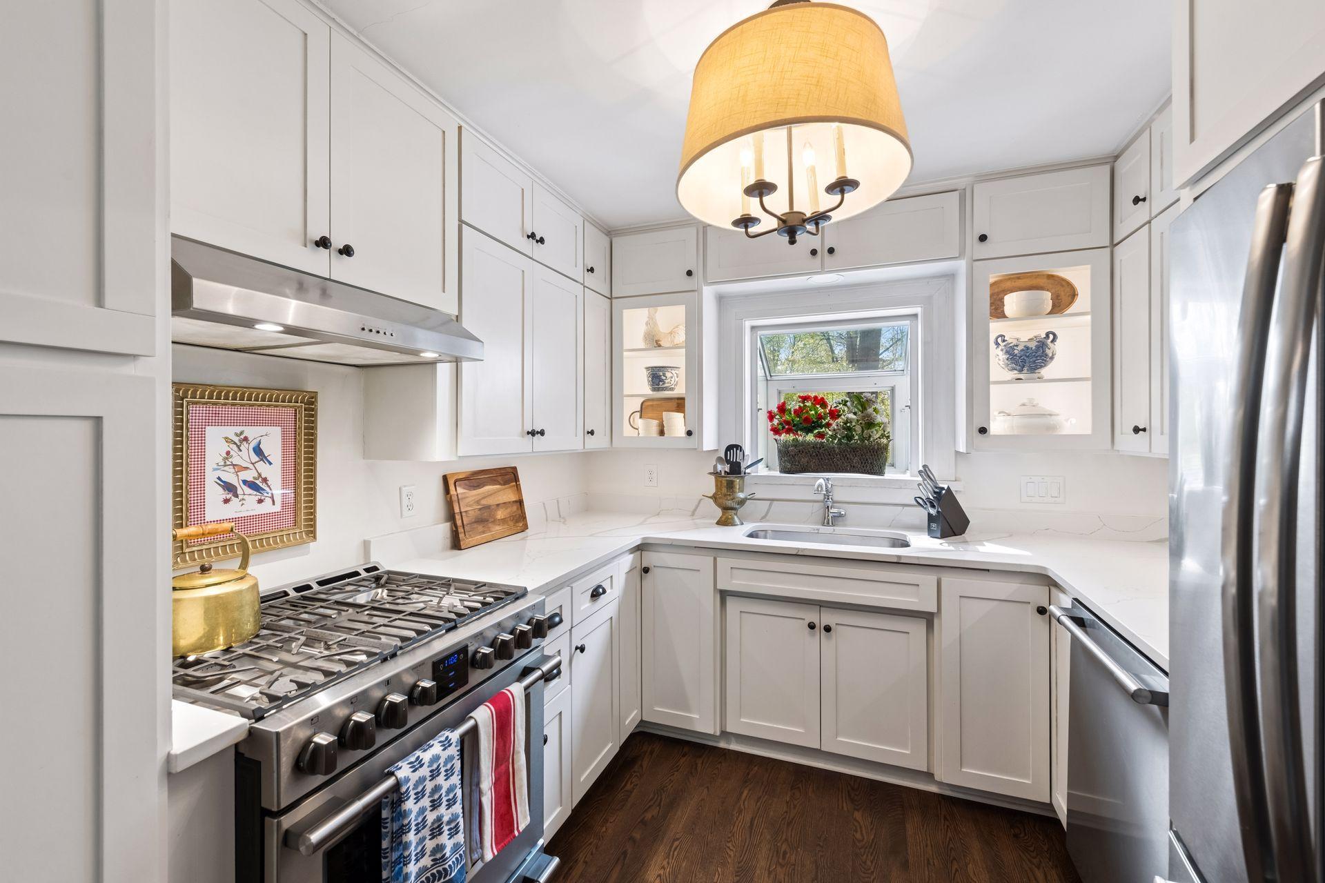 The remodeled kitchen includes new appliances, countertops, and cabinet doors
