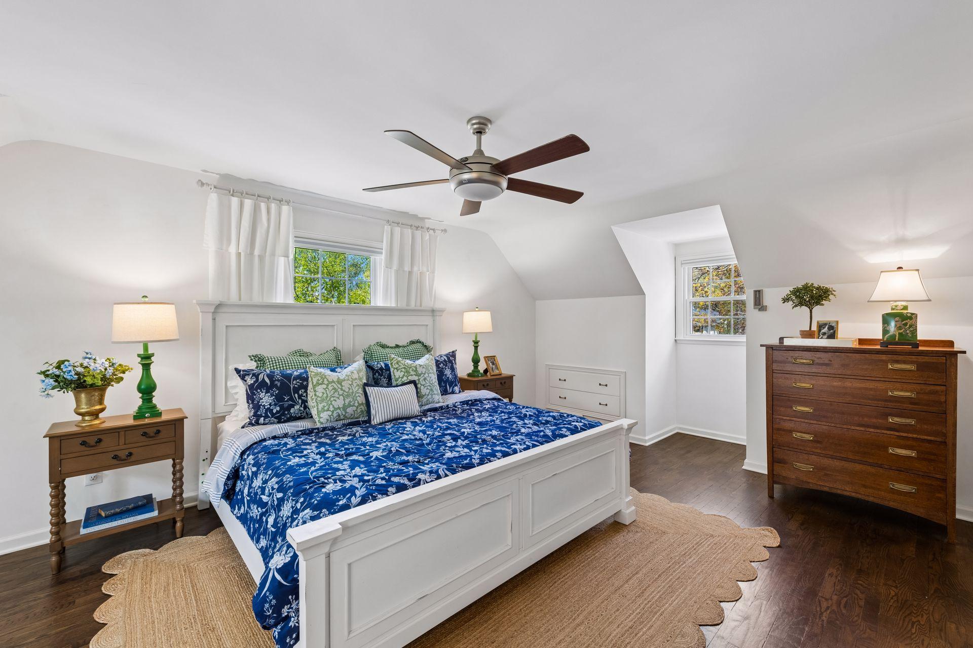 Light and bright primary bedroom with refinished hardwood floors