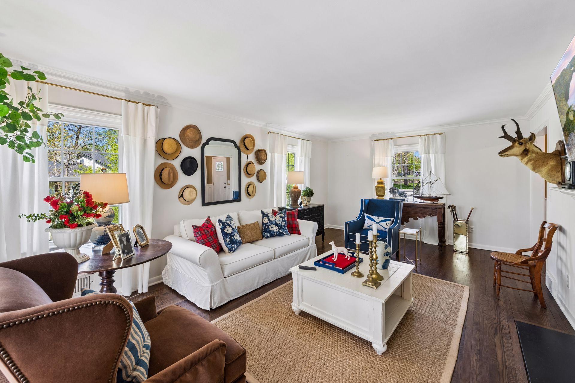 The living room features natural light and refinished hardwood floors