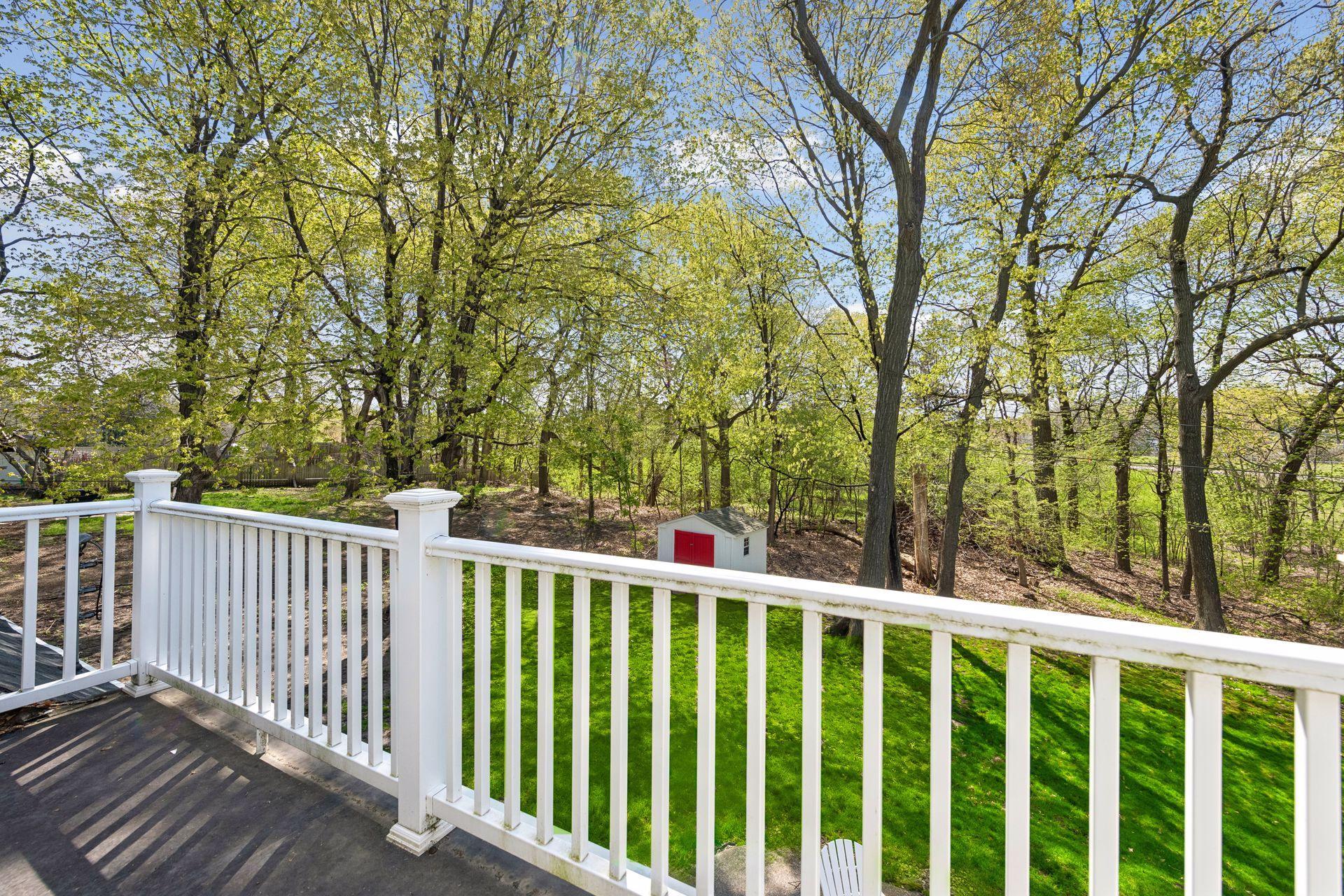Upper-level deck overlooks the private backyard