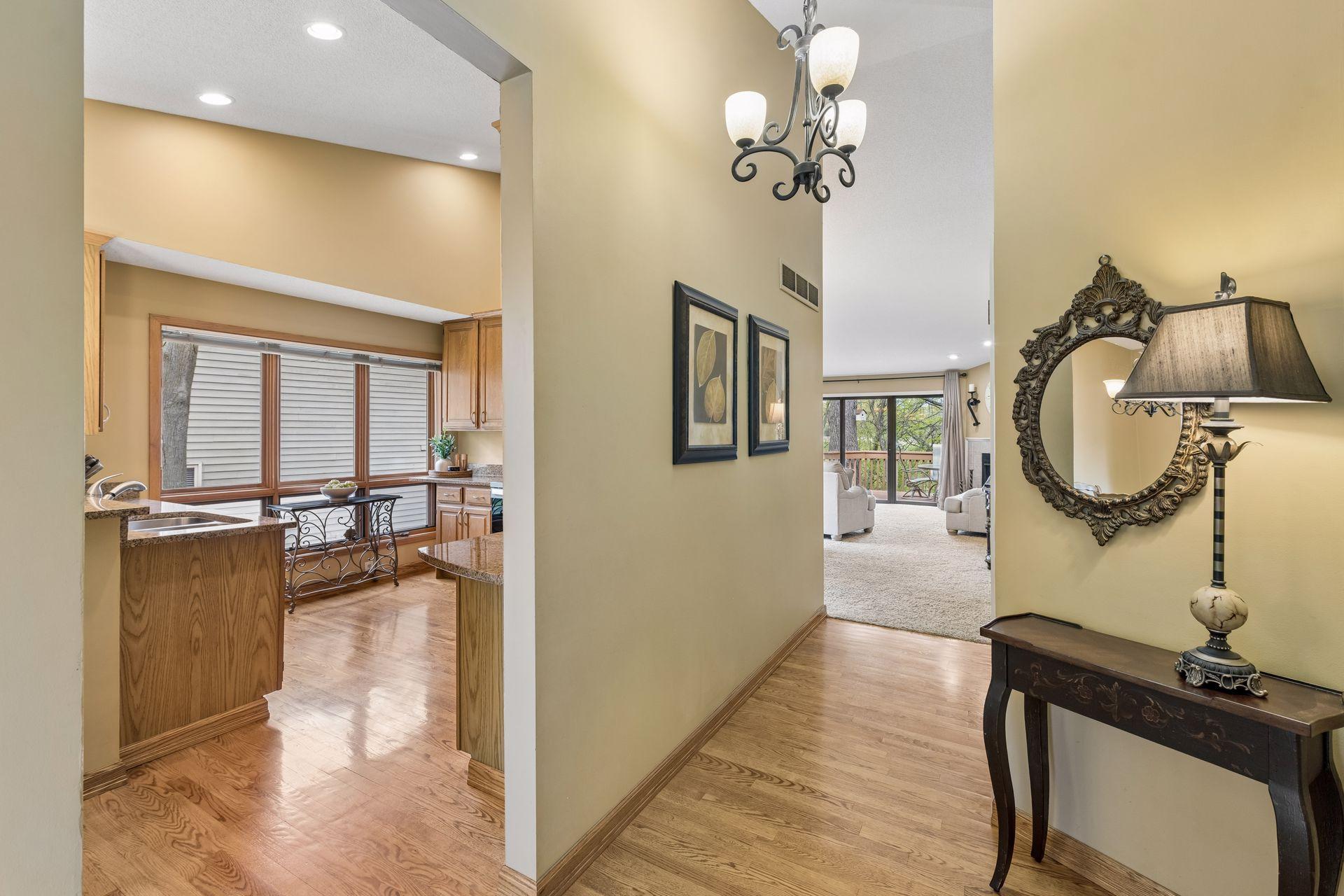 The generous foyer welcomes you with beautiful oak floors and open sightlines to the kitchen and living room, creating a bright, spacious feel.