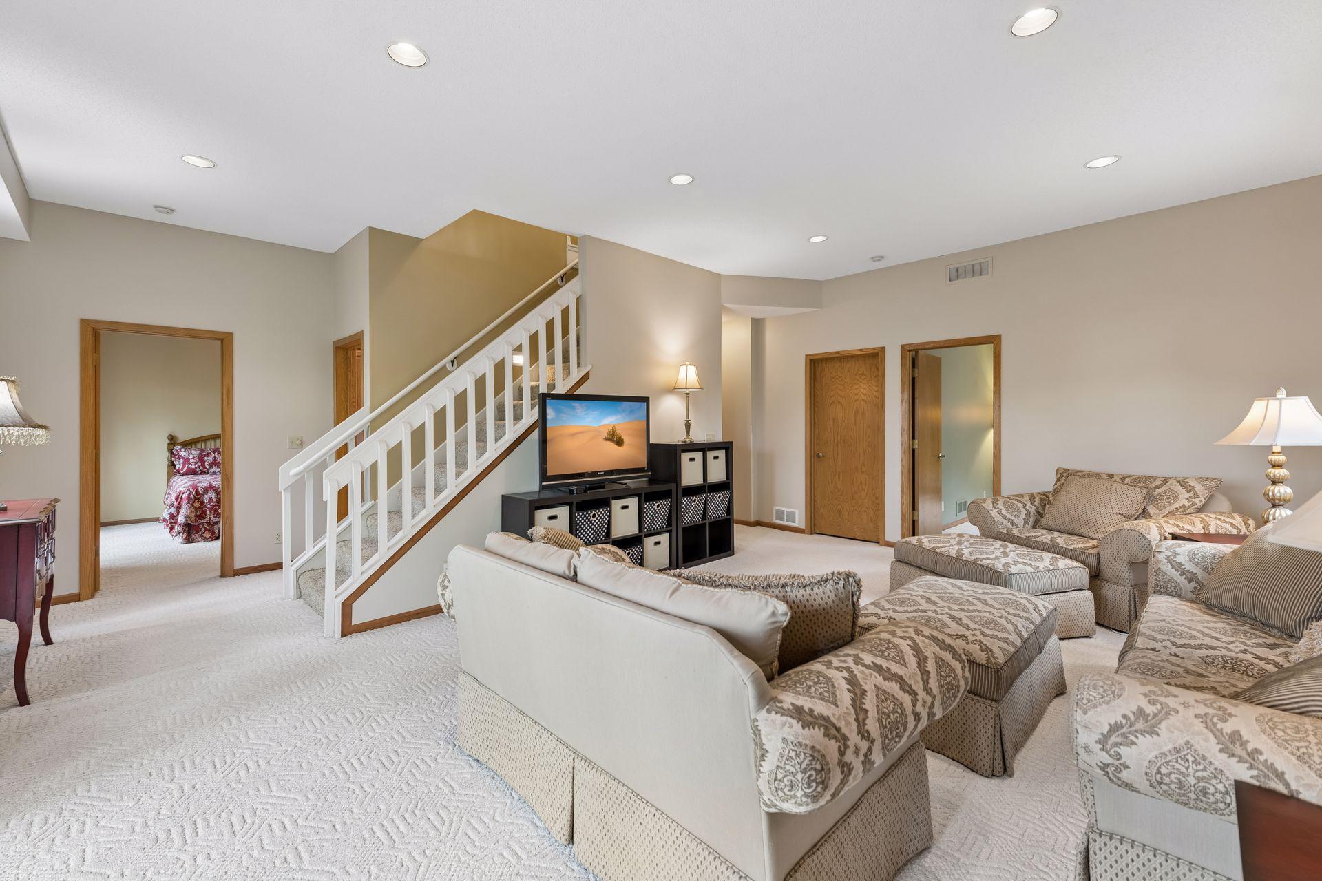 The lower-level family room is central to both of the bedrooms. The laundry room is located adjacent to the staircase.