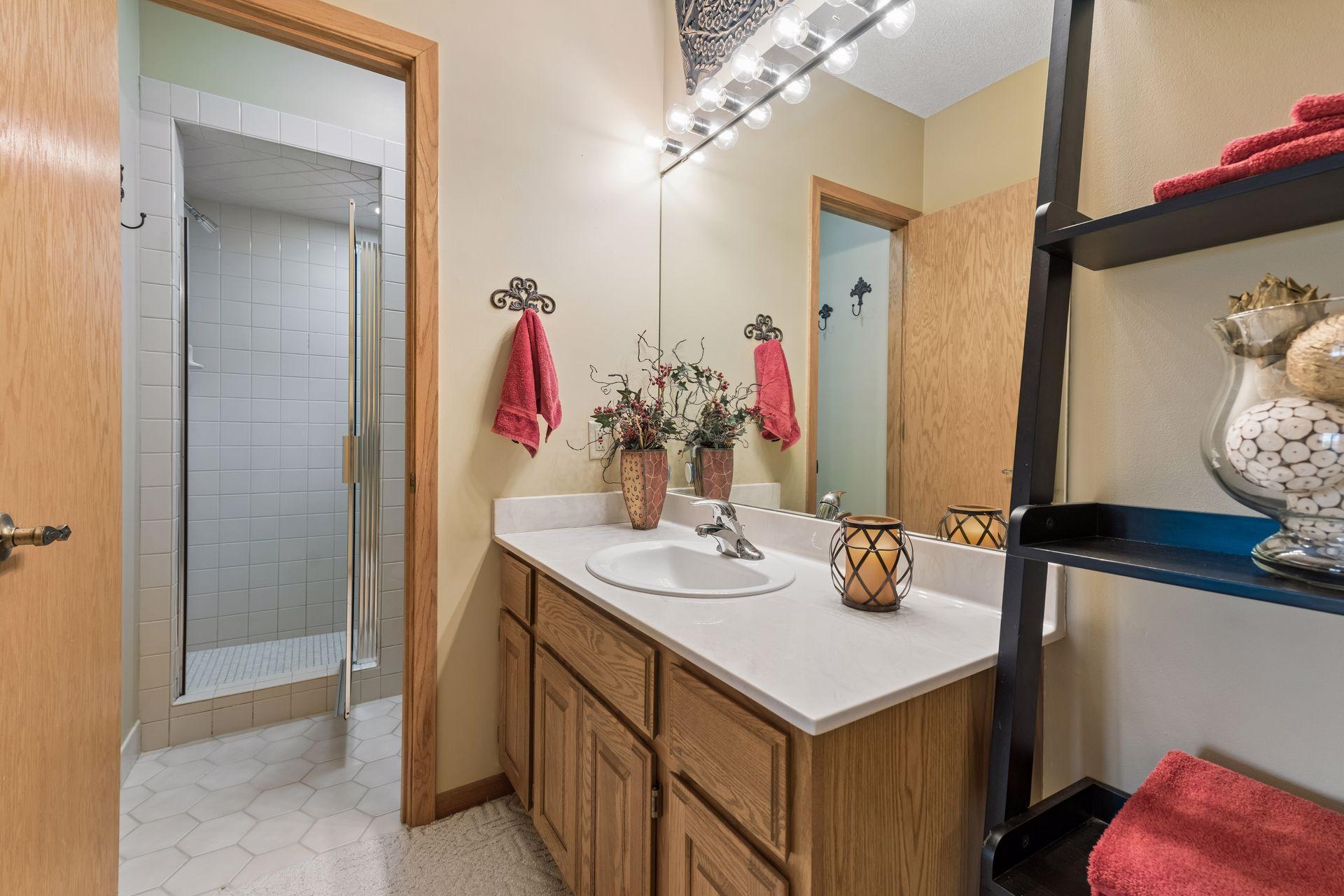 Three-quarter walkthrough bathroom serving the lower-level bedrooms and family room.